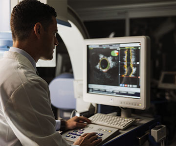A medical professional studies a test result on the computer. LInks to What to Give A medical professional studies a test result on the computer. LInks to What to Give